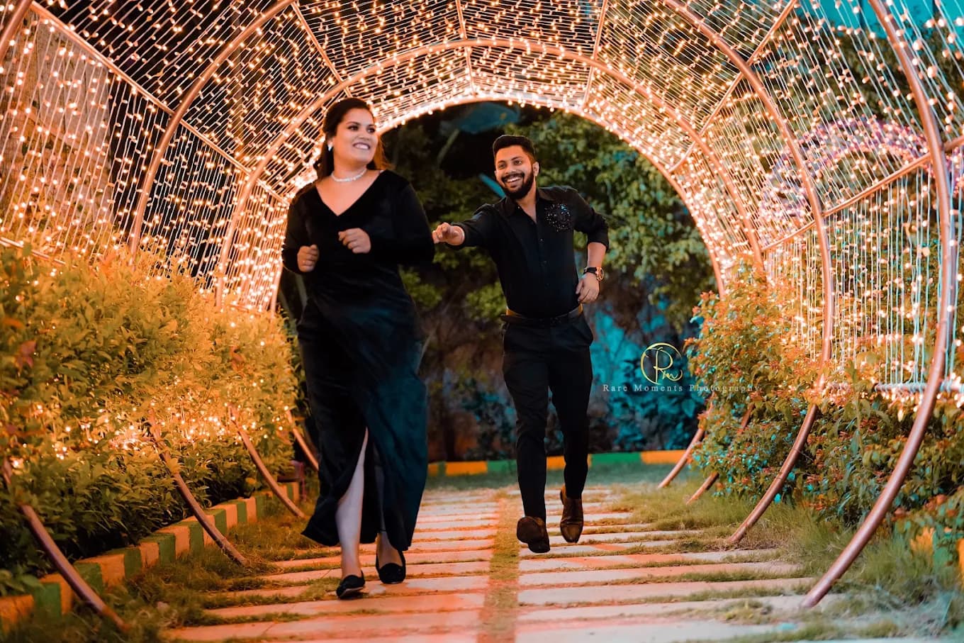 Couple's Joyful Walk Through Fairy Light Tunnel